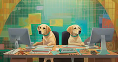 Two yellow English Labradors working on computers, with design papers scattered on the tabletop.